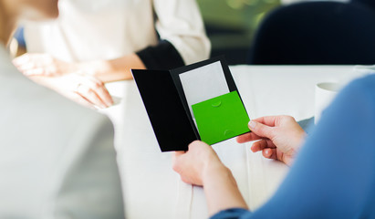close up of woman hands holding restaurant bill