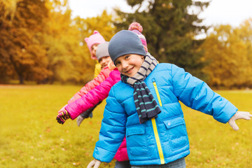 group of happy children having fun in autumn park