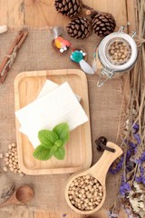 Tofu and soybeans on wood background.