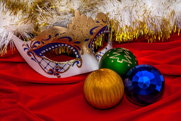 The mask with Christmas toys on red background