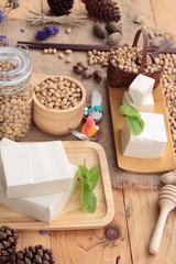 Fototapeta na wymiar Tofu and soybeans on wood background.