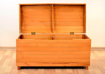 Empty chest with the lid opened. Big brown wood trunk on the floor.
