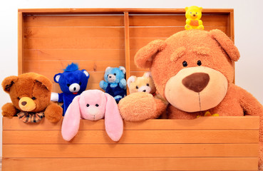 Child trunk with a big teddy bear and small plush toys. Chest with cute baby toys.