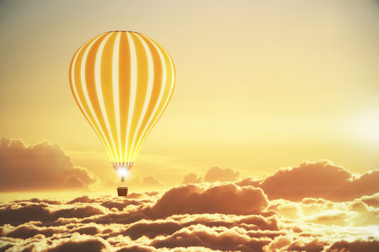 Balloon above the clouds at sunset