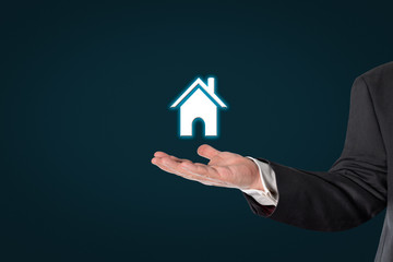 Fototapeta na wymiar Businessman holding a virtual house symbol