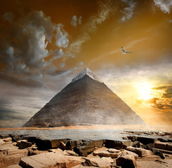 Fototapeta na wymiar Pyramid under clouds