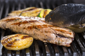cooking beef steak on a grill in the restaurant
