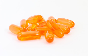 Vitamin E supplement capsules closeup on a white background