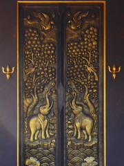 Tracery golden doors in a temple of Thailand