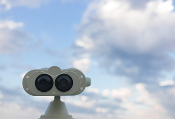 Telescope and sky with clouds