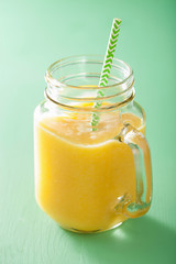 healthy mango pineapple smoothie in mason jars