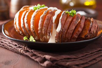 Baked hasselback potato with sour cream