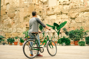 Young male is riding a bicycle in Barcelona - 95478002