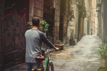 Young male is riding a bicycle in Barcelona - 95478014