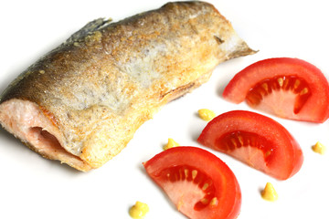 decorated plate with fried fish: river trout and tomatoes on white background