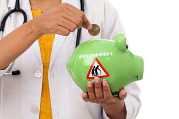 Young doctor woman holding a piggy bank