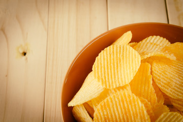 potato chips on wood - soft focus with vintage film filter