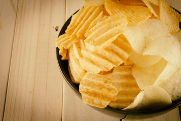 potato chips on wood - soft focus with vintage film filter
