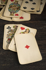 old playing cards on a wooden table