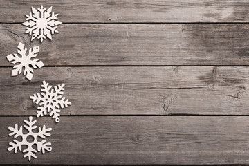 Snowflakes on grunge wooden background