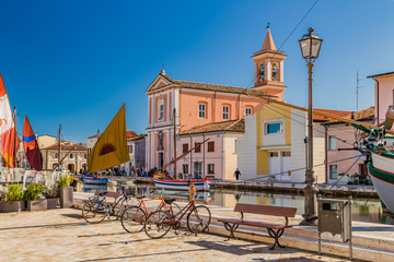 Church, boats and bycicles on Canal Port