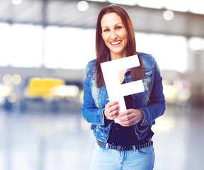 woman holding the F letter