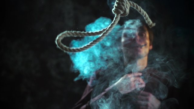 Social commercial. Man smoking cigarette. Noose loop rope for suicide falling. Slow Motion 400 fps