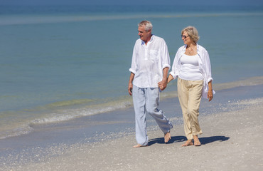 Happy Senior Couple Walking Holding Hands Tropical Beach