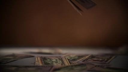 Falling dollars isolated on dark black background Slow Motion 400 fps