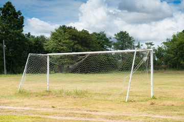 The old Soccer goal on the old football field at cloudy.