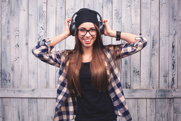 girl in glasses, headphones and black beanie