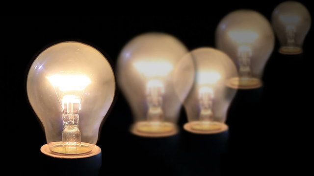 A light bulb illuminates a dark room, much like an idea in our mind.