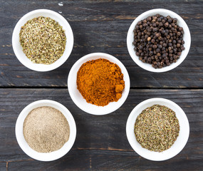 Spices and herbs in  bowls.
