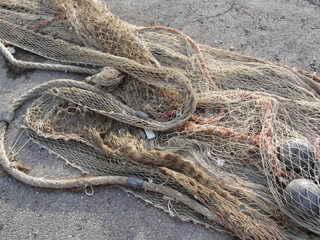 Weathered fishing nets on a traditional harbor pier in Livorno, Tuscany, Italy