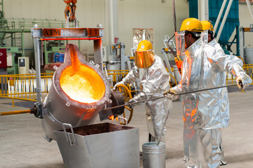 Baku, Azerbaijan-October 2015- workers melting metal Smelting in a metallurgical plant. Molten...