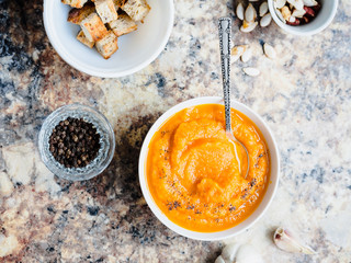 Autumn pumpkin soup in a white plate, vegan dinner