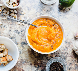 Autumn pumpkin soup in a white plate, healthy lunch