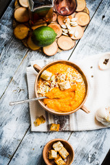 Pumpkin soup with carrots and homemade croutons in clay pots, ru