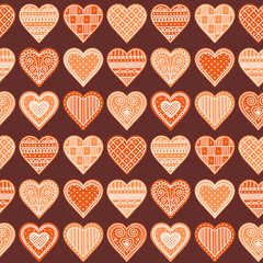 Pattern with gingerbread hearts. Cute Christmas background with hand drawn cookies. Seamless winter pattern. Brown colors.