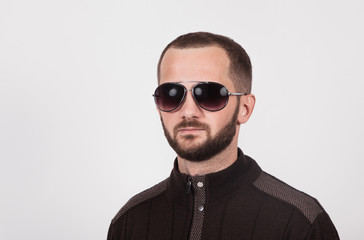 Fototapeta premium a man on a white background in a brown jacket with glasses