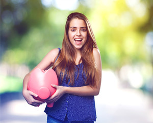 young cute woman with a big piggy bank