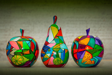 work of modern art - decorative apples and pear on a green background