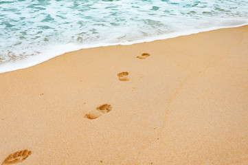 Fototapeta na wymiar Footprints in the sea sandy beach on a vacation time in Phuket,