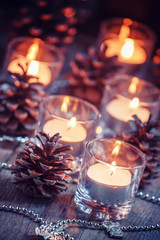 Christmas and New Year's background with candles, fir cones and
