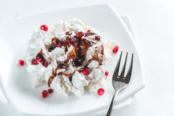 Portion of meringue with pomegranate seeds