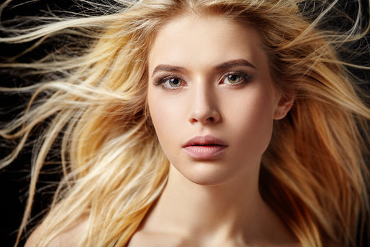 Portrait of beautiful  blonde woman with flying hair.