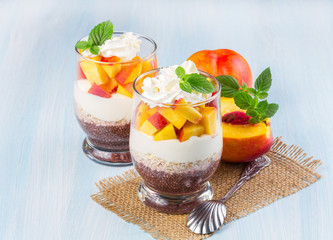 Chia seeds with oat flakes and peaches on a wooden table