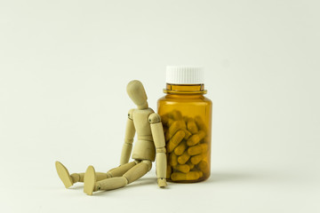 Wooden doll and pills