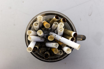 Cigarette buds in a coffee cup