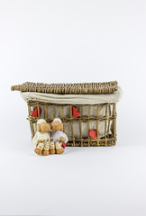 Two sheep figurines in front of a vintage rattan basket